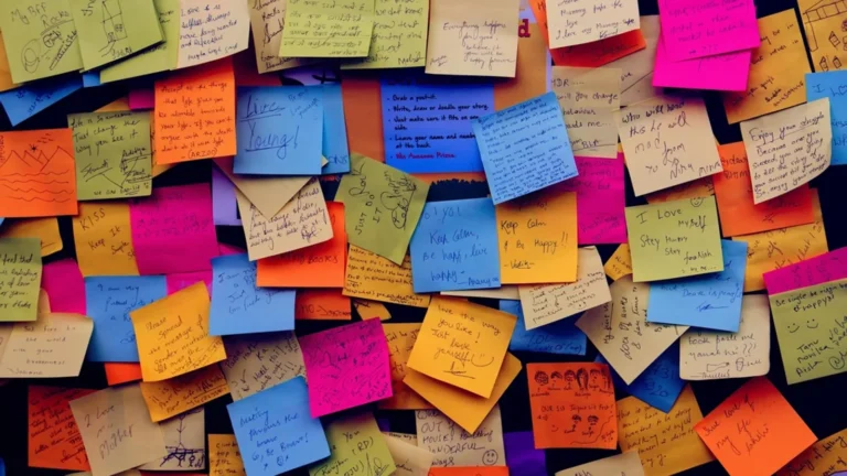 Wall of handwritten sticky notes from a naming brainstorm, the manual half of using a YouTube channel name generator